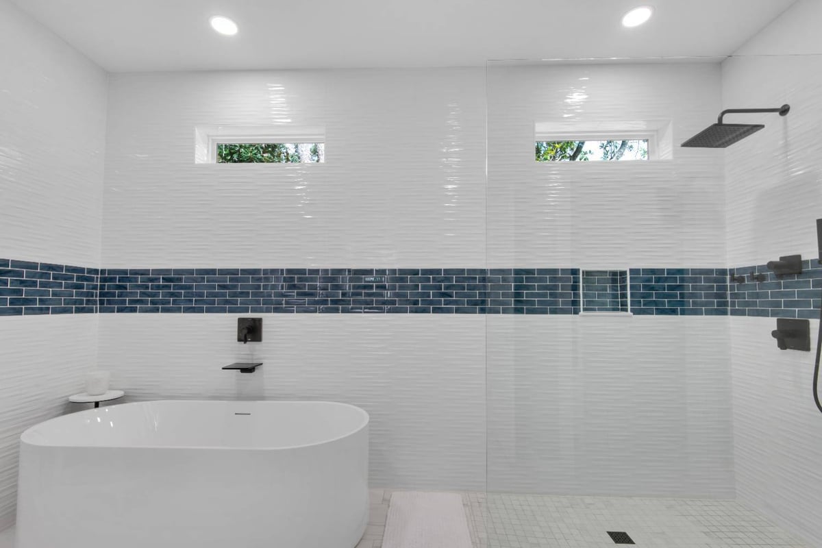 modern custom home bathroom with freestanding tub and blue accent tile by EZ Modern Homes in Pensacola, FL The Lafon-optimized