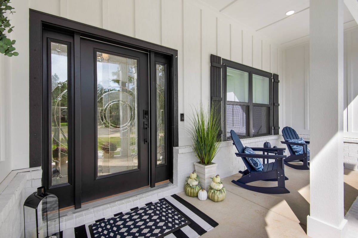 modern front entry with glass door and rocking chairs by EZ Modern Homes in Pensacola FL The Lafon-optimized