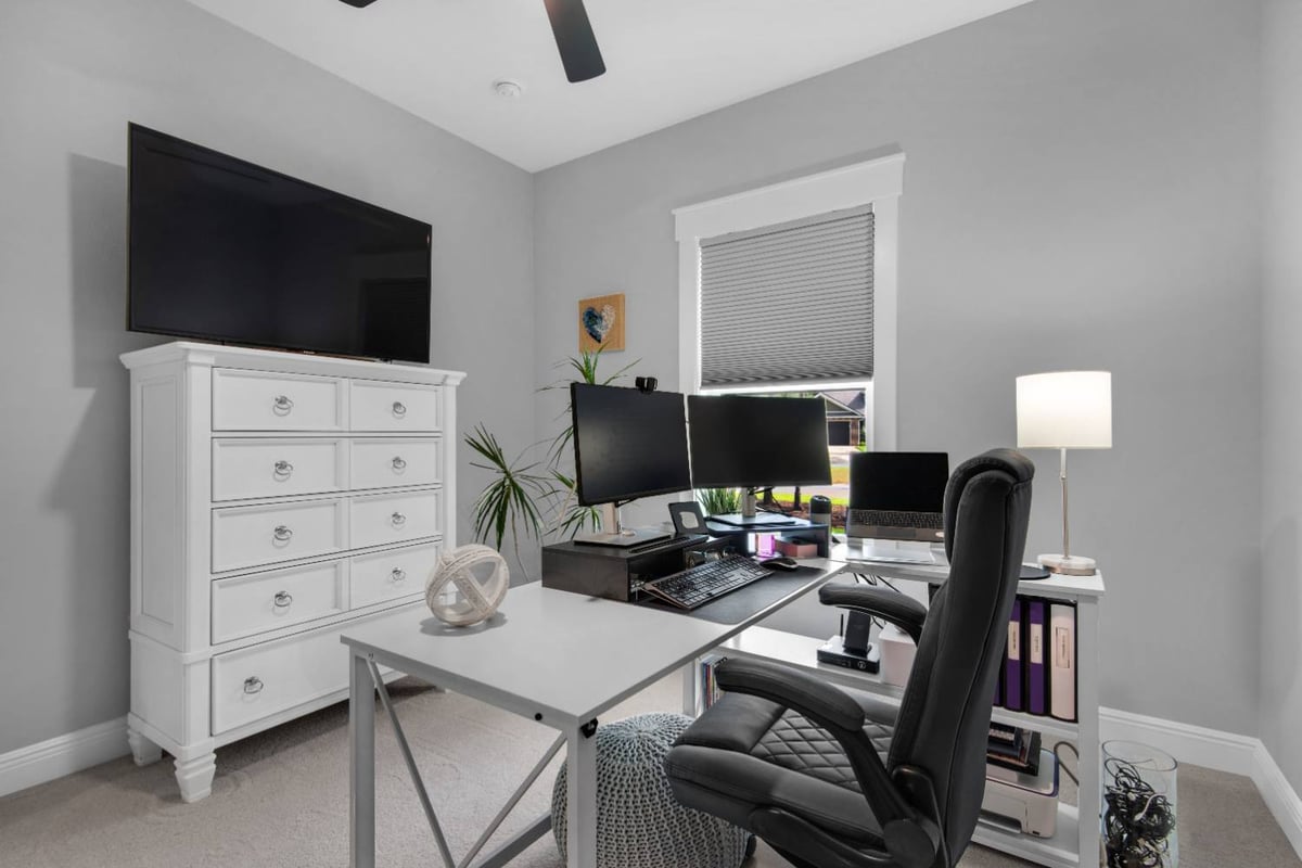 office with dual monitors and storage furniture in Pensacola custom home by EZ Modern Homes The Lafon-optimized