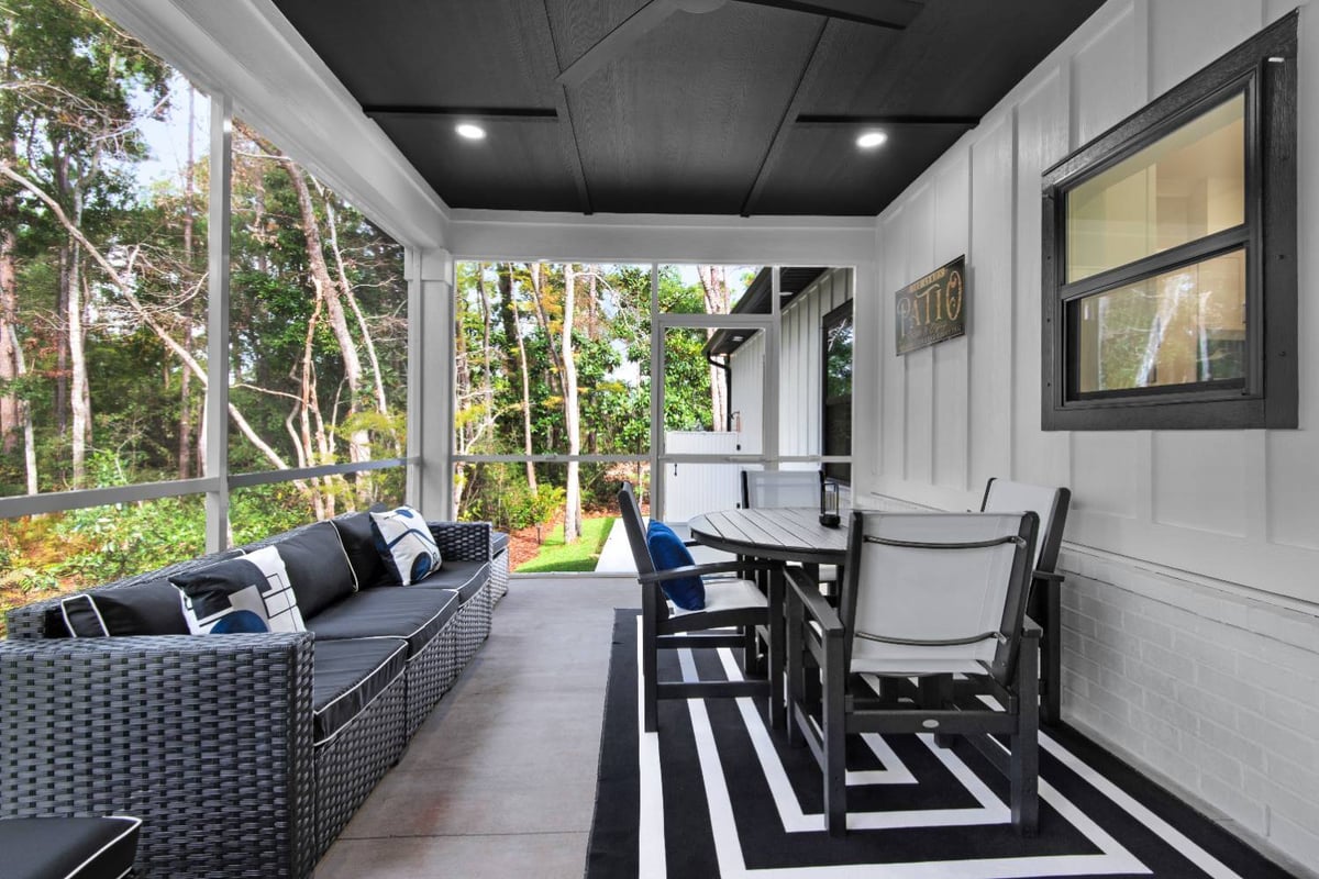 outdoor dining space on covered patio in Pensacola FL custom home by EZ Modern Homes The Lafon-optimized