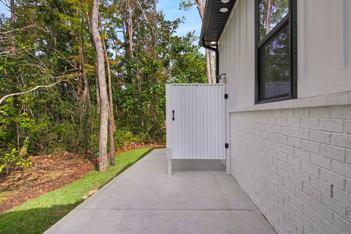side yard walkway and exterior wall of custom home by EZ Modern Homes Pensacola, FL The Lafon-optimized