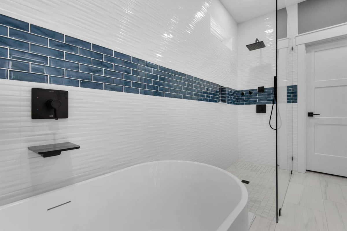 walk in shower with glass panel and freestanding tub in Pensacola custom home by EZ Modern Homes The Lafon-optimized