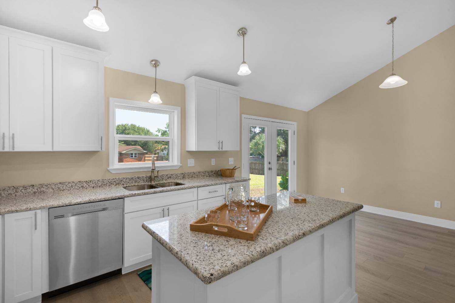 Kitchen with sink under window and backyard view in Pensacola FL custom home The Pins-optimized