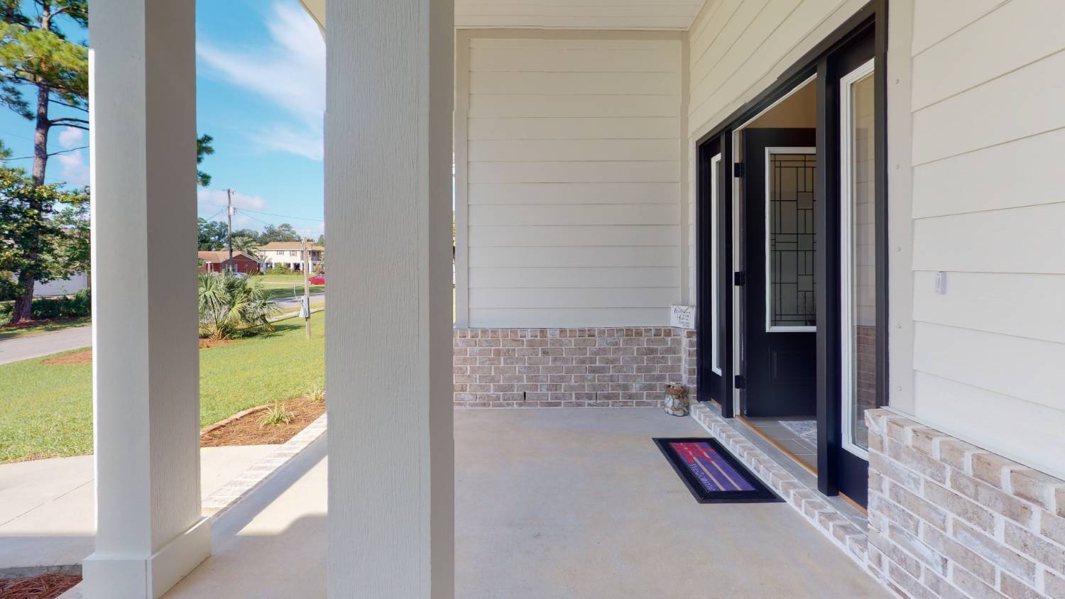 Front entry porch and doorway of EZ Modern Homes The Lafon custom home in Pensacola, FL-optimized