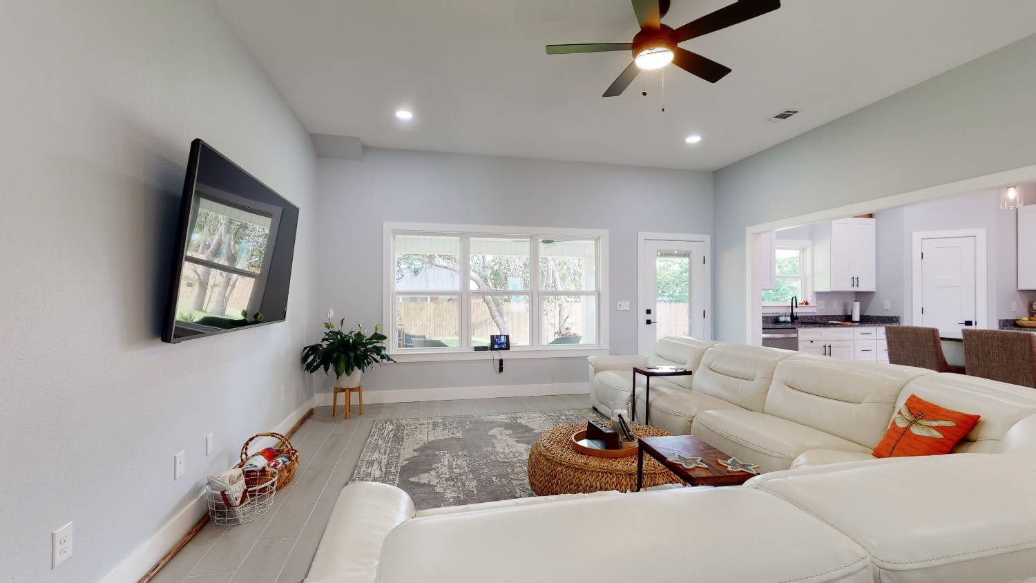 Living room in EZ Modern Homes The Lafon custom home with large windows and sectional sofa in Pensacola, FL-optimized