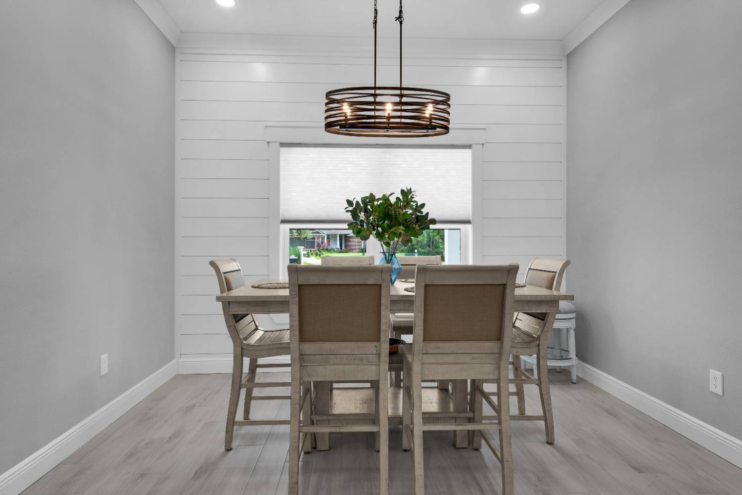 Symmetrical dining room setup with table and window in The Lafon custom home by EZ Modern Homes Pensacola, FL-optimized