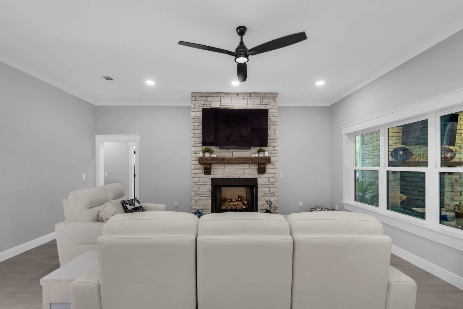 living room view with fireplace and ceiling fan by EZ Modern Homes Pensacola FL The Lafon-optimized