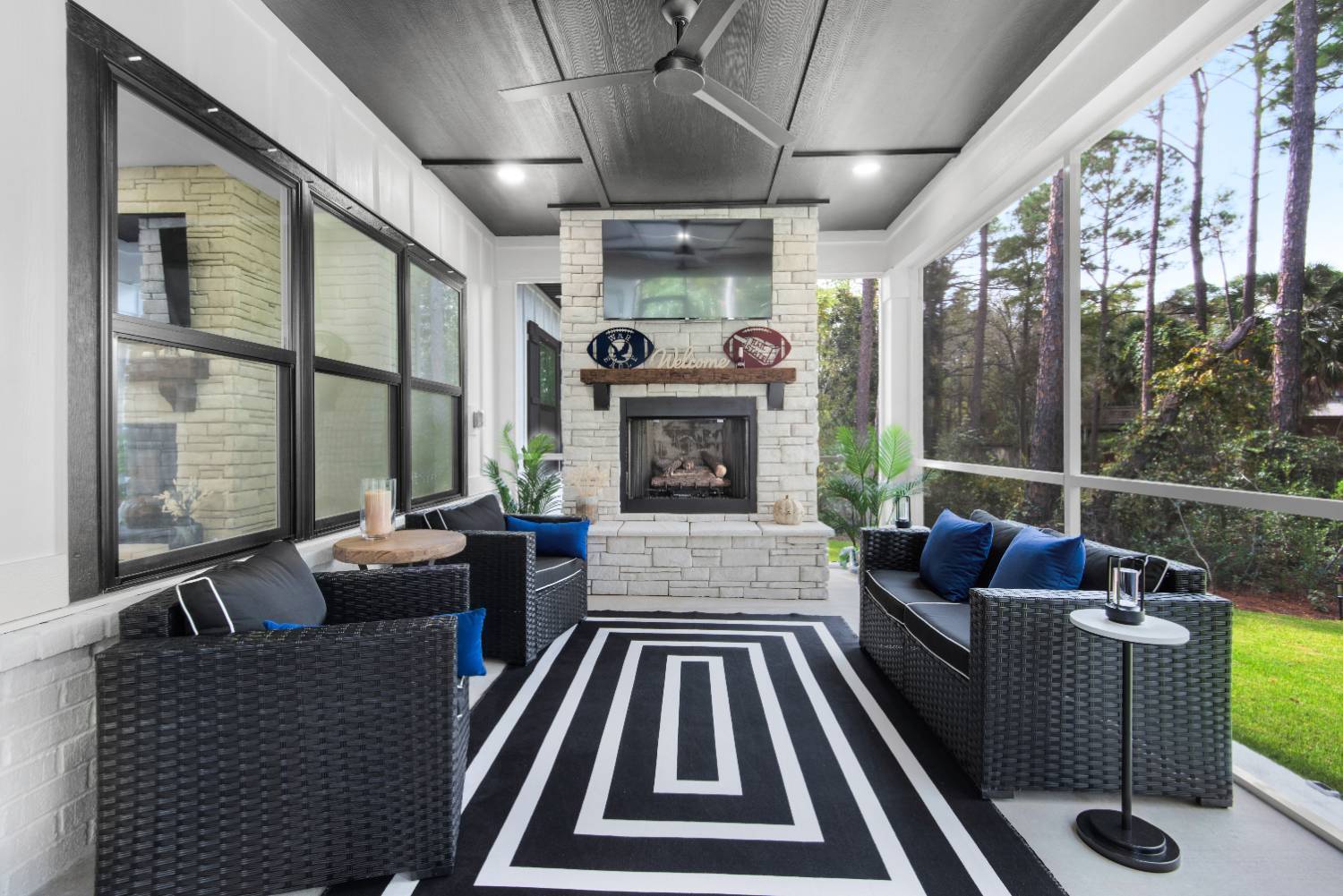 screened porch with fireplace and seating in custom home by EZ Modern Homes Pensacola, FL The Lafon-optimized